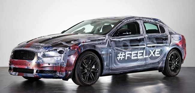 Jaguar has released a new teaser image of the 2015 XE, ahead of its debut later this year. The image reveals Jaguar's entry-level sedan wrapped up in white camouflage.
The XE adopts the same front fascia as the XF - a rectangular grille with nice slender headlamps.