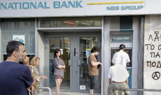 People line up to withdraw cash from an ATM on the island of Crete, Greece on June 28, 2015 (Reuters)