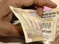 Rupee hits two-week high; oil, defence buying hurts