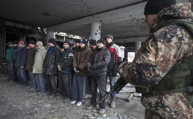 Ukrainian Prisoners Forced to Hunt for Dead Comrades in Airport Rubble