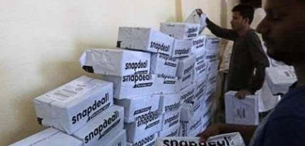 Employees of Snapdeal sort out delivery packages inside their company fulfilment centre