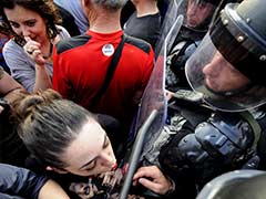 In Powerful Photo of Macedonian Protests, Woman Uses Police Shield to Apply Lipstick