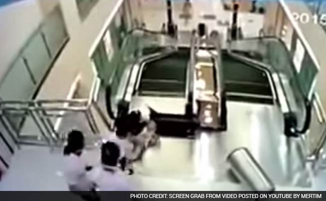 Chinese Woman Dies After Falling Into Escalator, But Saves Son