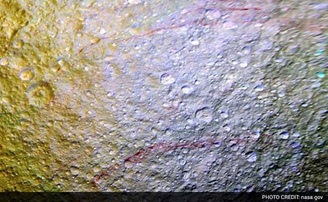 NASA Probe Spots Unusual Red Arcs on Icy Saturn Moon