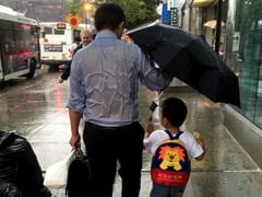 What's Not to Love About This Dad Braving the Rain For His Son?