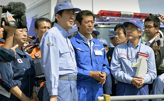 Japanese PM Visits Flood-Hit Town as Rescuers Search for Missing