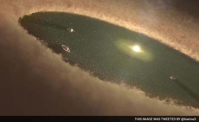 Astronomers See Planet Still Growing in its Stellar Womb