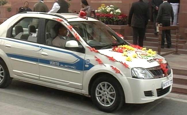 Minister Makes Green Statement, Rides Electric Car to Parliament