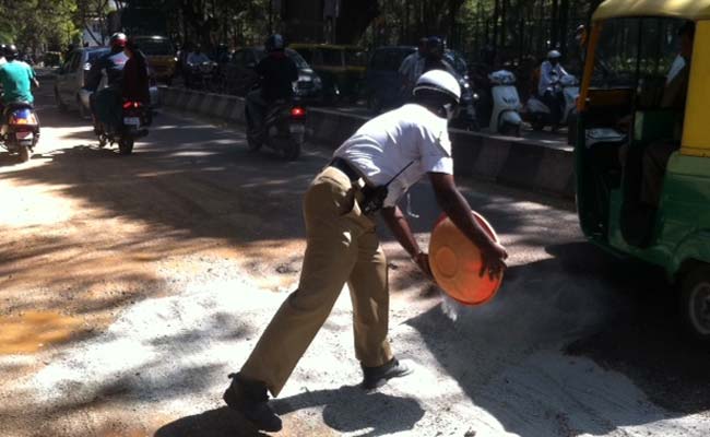 My Monday Morning Hero - A Traffic Policeman Filling Potholes