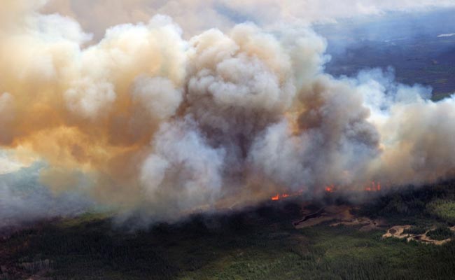 Helicopters, Trucks Set To Remove Thousands North Of Canadian Wildfire