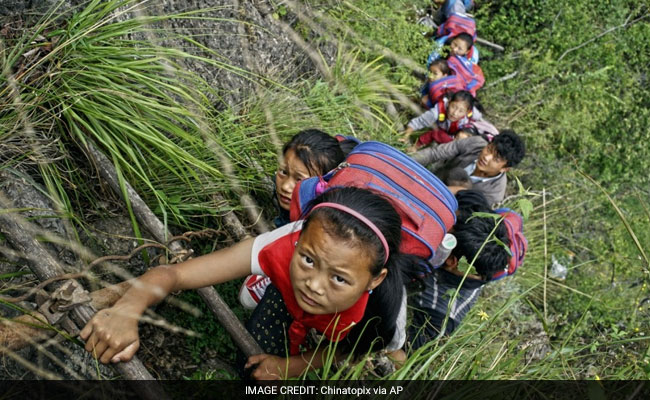 Here, Children Climb 2,625-Foot Ladder To Get To School. One Way.