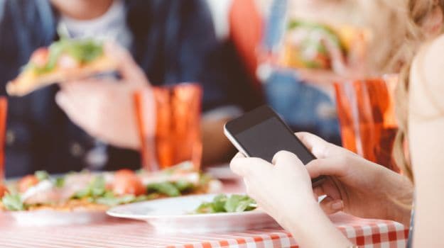 At the Dinner Table: Texting is OK But Not Facebook