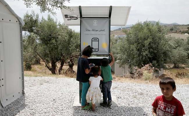 Sun-Powered Phone Charger Gives Migrants In Greece Free Electricity