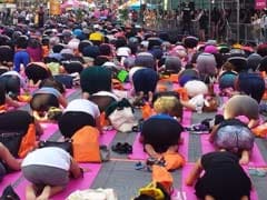 Thousands Of Yogis Hit Times Square To Welcome Summer