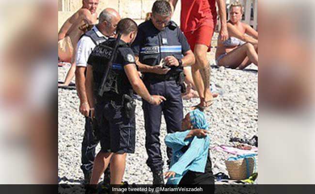 Viral Photos Of Woman Surrounded By Cops Add Fuel To French Burkini Debate
