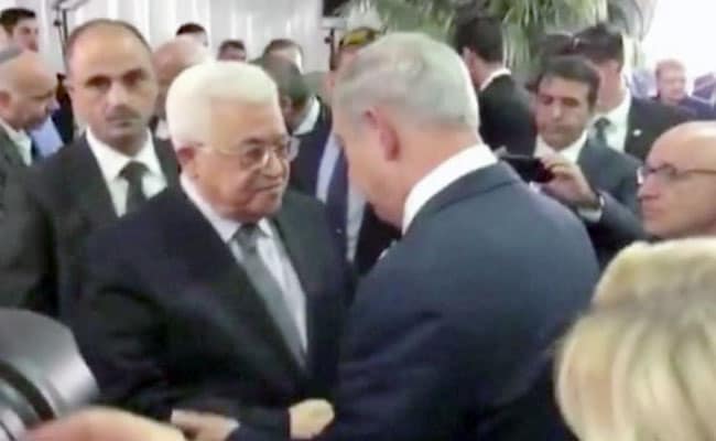 Palestinian President, Israeli Prime Minister Shake Hands At Peres Funeral