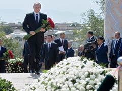 Vladimir Putin Lays Flowers At Islam Karimov's Grave