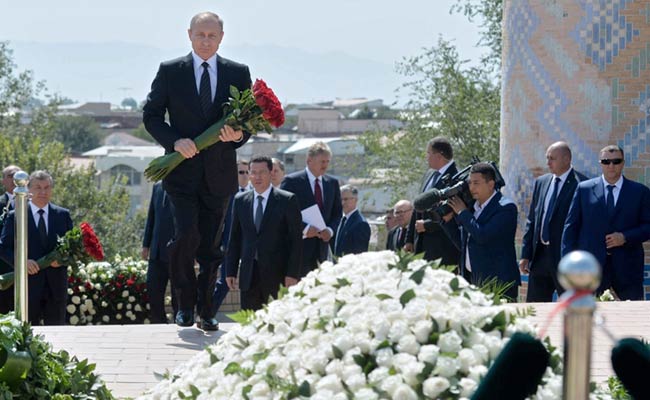 Vladimir Putin Lays Flowers At Islam Karimov's Grave