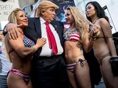 Bikini-Clad Models Surround Fake Donald Trump In New York City Stunt