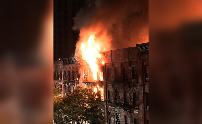 New York City Firefighter Stages Dramatic Rescue In Fatal Blaze