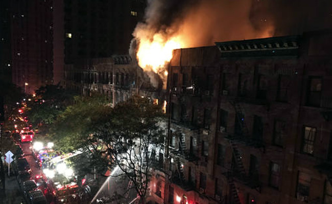 New York City Firefighter Stages Dramatic Rescue In Fatal Blaze