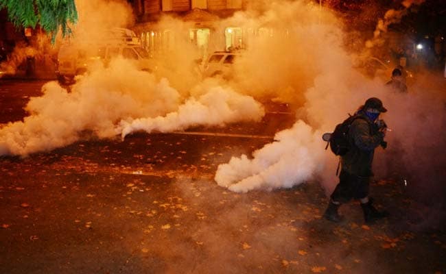 Anti-Trump Protesters March Amid Tear Gas, Flash Grenades