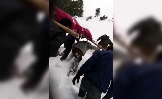 soldier carries mothers dead body
