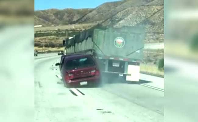 Truck Drags Car Along Highway As Driver Waves For Help