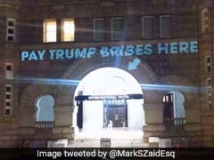 'Pay Trump Bribes Here,' On Wall Above An Entrance To The Trump Hotel In Washington DC