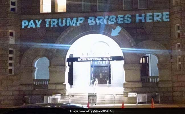 'Pay Trump Bribes Here,' On Wall Above An Entrance To The Trump Hotel In Washington DC