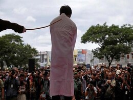 Indonesian Men Caned For Gay Sex Before Jeering Crowd Indonesian Men Caned For Gay Sex Before Jeering Crowd