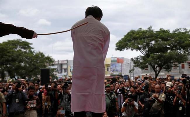 Indonesian Men Caned For Gay Sex Before Jeering Crowd