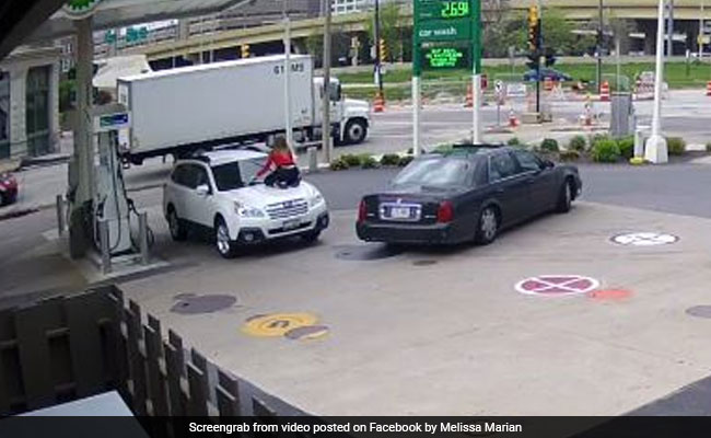 Caught On Camera: Woman Jumps On Top Of Her Car To Stop Thieves