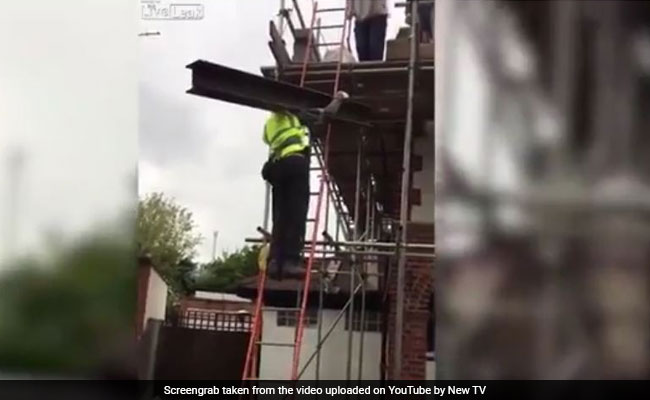 Video: No Harness, Worker Climbs Shaky Ladder With Metal Beam On Shoulder