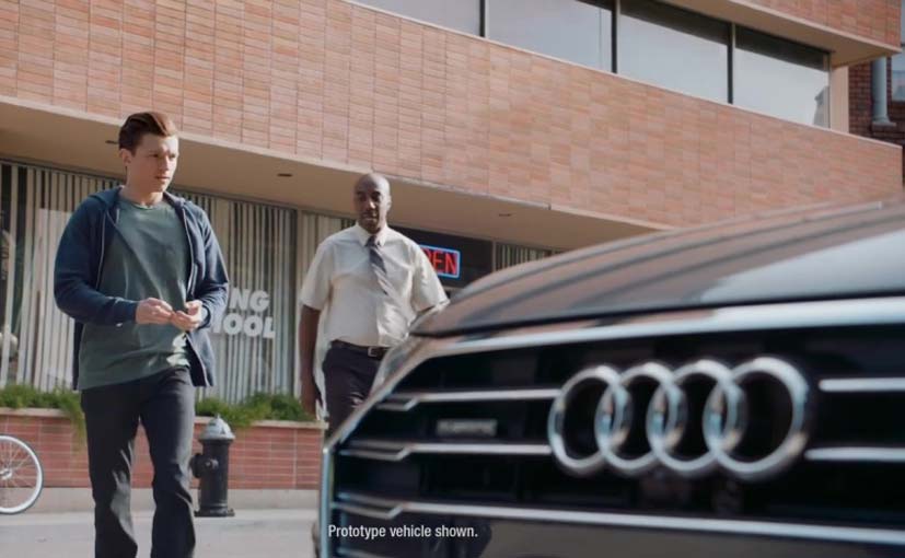 The short video shows Peter Parker in a brand new Audi SUV prototype driving with an annoying instructor who looks for every reason to dock points for driving fast, not holding the steering wheel correctly, braking too hard and too close to the car in front, etc. The video however does showcase the new Audi's capabilities of semi autonomous driving, auto braking and auto parking which makes Peter Parker's job a lot lot easier.