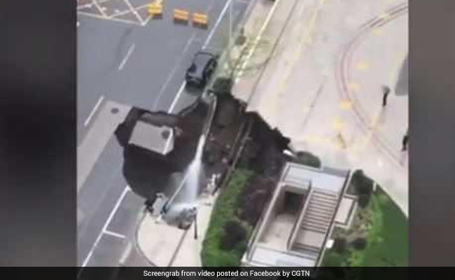 Giant Sinkhole Appears On Road, Swallows Car And Tree