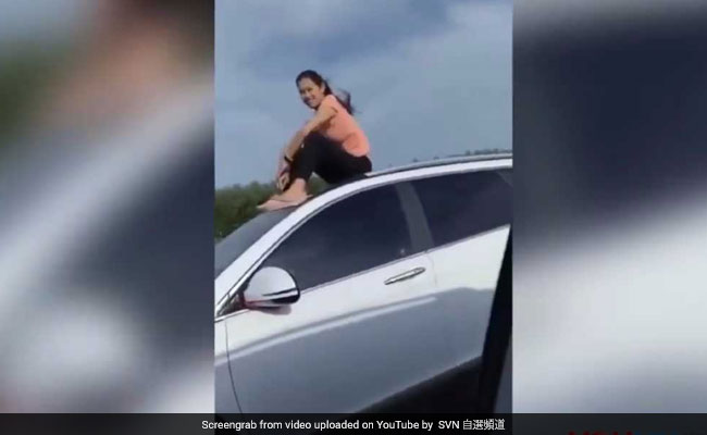 Woman Spotted Riding On Top Of Moving Car, Footage Goes Viral