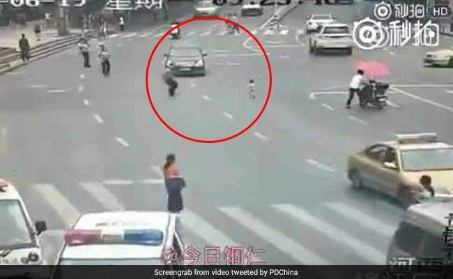Watch: Hero Cop Runs In Front Of Car To Save Child