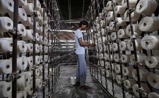 An employee works at a textile mill in Meerut.