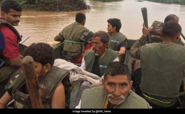 Rescue Teams Airlift, Piggyback, Row People Down In Rain-Ravaged States