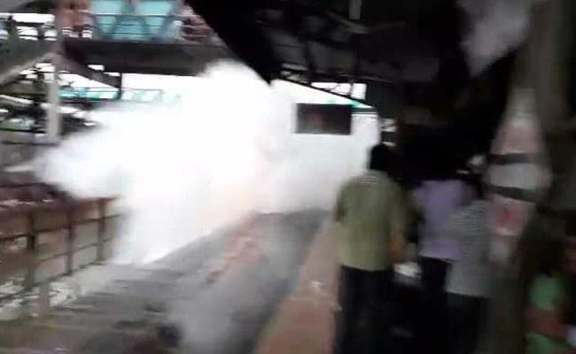 Train speeds dangerously through flooded station, drenching commuters; video