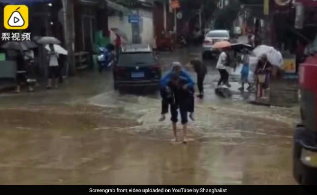 Heartwarming Video Shows Elderly Man Carrying Wife On Back Over Puddle