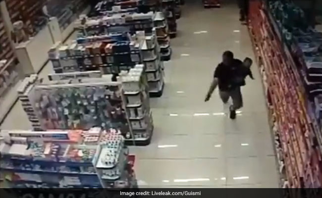 On Camera, Cop Shoots And Kills 2 Robbers While Holding Son In His Arms