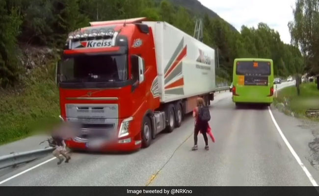 Heart-Stopping Moment Child Runs Into Traffic, Is Almost Run Over By Truck