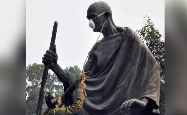 Delhi Lawmakers Tie Protective Mask On Mahatma Gandhi's Statue