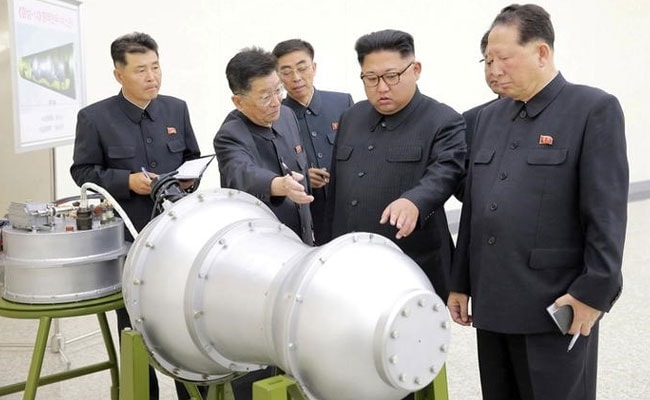 North Korea's Kim Jong Un Fetes Rocket Scientists, Promises More Weapons