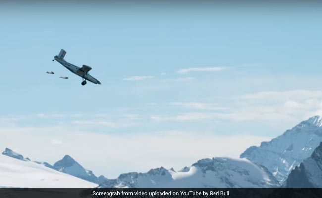 Watch: Daredevils Jump Off Mountain, Land Inside A Plane In Insane Mid-Air Stunt