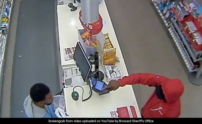 Watch: Robber Points Gun At Cashier. Intense Stare-Down Follows...
