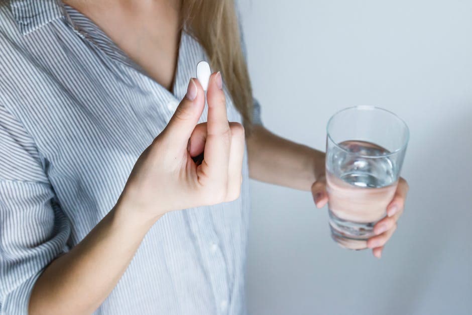 woman taking pill