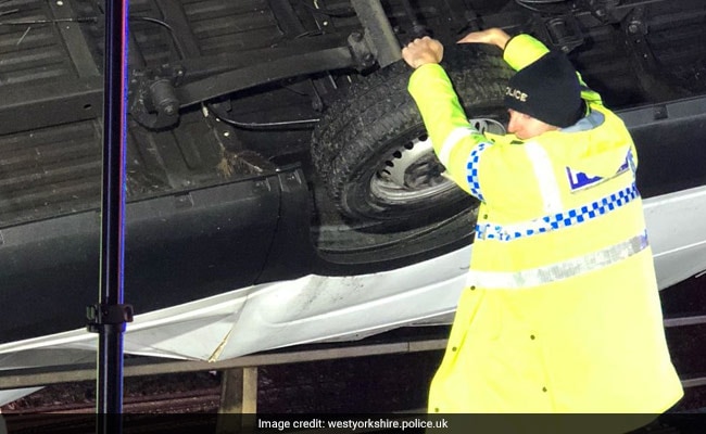 Cop Holds On To Van Hanging Off Bridge With Bare Hands. Image Is Viral